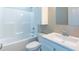 Bright bathroom features a combination tub and shower plus a vanity and cabinet above the toilet at 818 E Holly St, Rocky Mount, NC 27801