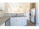 Well-lit kitchen featuring stainless steel appliances and granite countertops at 818 E Holly St, Rocky Mount, NC 27801