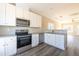 Modern kitchen with stainless appliances, granite countertops, and white cabinets at 818 E Holly St, Rocky Mount, NC 27801