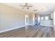 Spacious living room with modern ceiling fan and connection to kitchen at 818 E Holly St, Rocky Mount, NC 27801