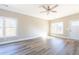 Inviting living room with bright windows and attractive hard wood floors at 818 E Holly St, Rocky Mount, NC 27801