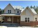 New construction home featuring a brick and siding exterior with modern architectural details at 829 Chapel Ridge Dr, Pittsboro, NC 27312
