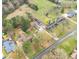 An aerial view exhibits the home's location in a lush, green setting with a nearby road at 928 Hanford Rd, Graham, NC 27253