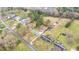 An aerial view showcases the home's position amongst neighboring homes and lush trees at 928 Hanford Rd, Graham, NC 27253