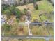 An aerial view displays the home's setting on spacious lots with mature trees at 928 Hanford Rd, Graham, NC 27253
