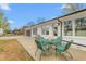 Charming backyard featuring an outdoor dining area, perfect for relaxing and entertaining guests at 928 Hanford Rd, Graham, NC 27253