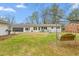 Lush backyard featuring a swing and patio area, perfect for relaxing and enjoying the outdoors at 928 Hanford Rd, Graham, NC 27253