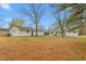 Expansive backyard featuring lush greenery, mature trees, and a detached garage for outdoor enjoyment at 928 Hanford Rd, Graham, NC 27253