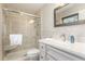 Updated bathroom featuring a glass door shower, granite countertop vanity, and neutral decor at 928 Hanford Rd, Graham, NC 27253