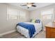 Bright bedroom with a ceiling fan, two windows, and stylish decor, offering a comfortable living space at 928 Hanford Rd, Graham, NC 27253