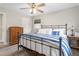 Inviting bedroom featuring a wood frame bed, soft lighting, and view into an adjacent room at 928 Hanford Rd, Graham, NC 27253