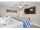 Bedroom with large mounted TV, plush bedding, and a sunlit window for natural light at 928 Hanford Rd, Graham, NC 27253