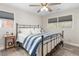 Cozy bedroom featuring a metal frame bed with blue and white bedding, and natural lighting at 928 Hanford Rd, Graham, NC 27253