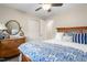 Bedroom showcases a beautiful wood dresser, ceiling fan and inviting decor, creating a peaceful retreat at 928 Hanford Rd, Graham, NC 27253