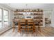 Dining area featuring a rustic wooden table, chairs, and custom shelving displaying liquor bottles at 928 Hanford Rd, Graham, NC 27253