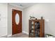 Welcoming entryway featuring a glass cabinet, wood-look flooring, and an attractive wood-stained front door with glass at 928 Hanford Rd, Graham, NC 27253
