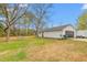 Spacious detached garage, surrounded by mature trees, offering ample parking and storage space at 928 Hanford Rd, Graham, NC 27253