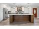 Well-lit kitchen showcasing a center island with marble countertops, stainless appliances, and modern lighting fixtures at 928 Hanford Rd, Graham, NC 27253