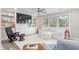 Cozy living room with built-in shelving, a comfortable white sofa, and a ceiling fan for added comfort at 928 Hanford Rd, Graham, NC 27253