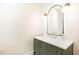 Stylish half-bathroom featuring a green vanity with gold fixtures and a modern mirror at 100 High Ridge Ln, Pittsboro, NC 27312