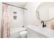 Bright bathroom with a white vanity, round mirror, hexagon tile shower, and tub with a curtain at 100 High Ridge Ln, Pittsboro, NC 27312