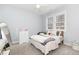 Cozy bedroom featuring neutral walls, carpet, ceiling fan, and natural light from the window at 100 High Ridge Ln, Pittsboro, NC 27312