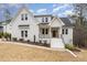Stunning two-story white brick home with a welcoming front porch and manicured landscaping at 100 High Ridge Ln, Pittsboro, NC 27312