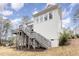 Exterior view of a home with white siding and a deck at 100 High Ridge Ln, Pittsboro, NC 27312