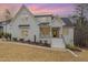 Charming two-story white brick home, bathed in the warm colors of the sunset sky at 100 High Ridge Ln, Pittsboro, NC 27312