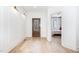 Bright hallway with wood floors, white trim, and a view into the bedroom at 100 High Ridge Ln, Pittsboro, NC 27312