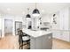 Open-concept kitchen featuring an island with a sink, stainless appliances, and white cabinets at 100 High Ridge Ln, Pittsboro, NC 27312
