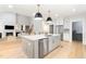 Spacious kitchen with stainless steel appliances, a large island, and an open view to the living room at 100 High Ridge Ln, Pittsboro, NC 27312