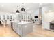 Bright, open kitchen with a large island, stainless steel appliances, and a view to the dining area and living room at 100 High Ridge Ln, Pittsboro, NC 27312