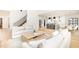 Bright living room featuring an open floor plan with hardwood floors connecting to the kitchen at 100 High Ridge Ln, Pittsboro, NC 27312