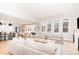 Open concept living room featuring hardwood floors, neutral decor, and large windows at 100 High Ridge Ln, Pittsboro, NC 27312