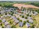 An aerial view highlights a residential neighborhood with mature trees and proximity to a construction site at 1009 Limeberry Ct, Clayton, NC 27520