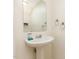 Bathroom featuring a pedestal sink and square mirror, plus chrome hardware at 1009 Limeberry Ct, Clayton, NC 27520
