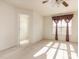 Bright bedroom featuring a closet door, carpeted floor, and window with decorative curtain at 1009 Limeberry Ct, Clayton, NC 27520