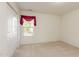 Bright bedroom features neutral carpeting, a window with red valance, and a closet for ample storage at 1009 Limeberry Ct, Clayton, NC 27520
