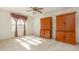 Carpeted bedroom with dark cabinets, a ceiling fan and a window with natural light at 1009 Limeberry Ct, Clayton, NC 27520