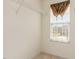 Walk-in closet with shelving, neutral carpet, and a window for natural light at 1009 Limeberry Ct, Clayton, NC 27520