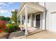 Welcoming front porch with a gray siding and white pillars at 1009 Limeberry Ct, Clayton, NC 27520