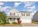 Charming two-story home with a well-manicured lawn and attached two-car garage at 1009 Limeberry Ct, Clayton, NC 27520
