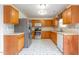 A kitchen with stainless steel appliances, a tile backsplash, and wood cabinets at 1009 Limeberry Ct, Clayton, NC 27520