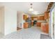Bright kitchen with stainless steel appliances, wooden cabinets, and durable tiled floors at 1009 Limeberry Ct, Clayton, NC 27520