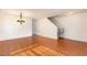 Open-concept living room with gleaming hardwood floors and a stairway at 1009 Limeberry Ct, Clayton, NC 27520