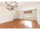 Spacious living room boasting gleaming hardwood floors and a modern chandelier at 1009 Limeberry Ct, Clayton, NC 27520