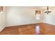 Neutral living room featuring hardwood floors, cream walls, and modern lighting at 1009 Limeberry Ct, Clayton, NC 27520