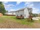 Spacious backyard with a deck, lawn, and play set surrounded by mature trees at 101 Lager Ln, Garner, NC 27529