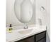 Powder room featuring a modern sink with elegant fixture, oval mirror, and sleek design at 101 Lager Ln, Garner, NC 27529